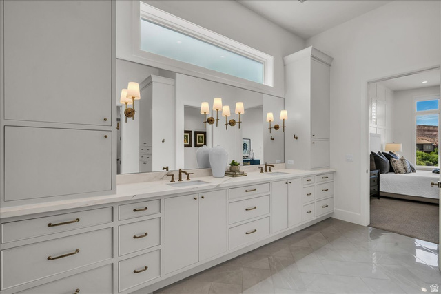 2608 Canyon Ridge Drive St. George, UT 84770 - Photo 35 of 86 Primary bathroom: dual vanity with integrated sinks, expansive mirror, and sconce lighting