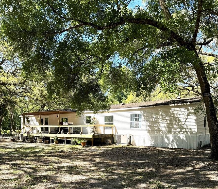 16314 Tiger Trail Spring Hill, FL 34610 - Photo 2 of 11 a view of a house with a big yard