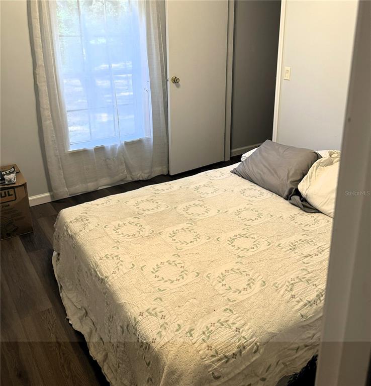 16314 Tiger Trail Spring Hill, FL 34610 - Photo 8 of 11 a bedroom with a bed and a mirror