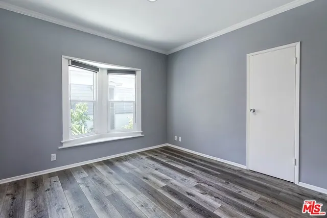 a view of room with window and hardwood floor