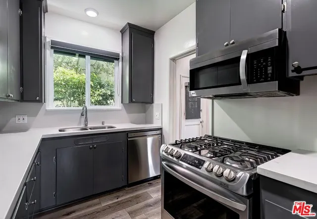 a kitchen with a stove and a sink