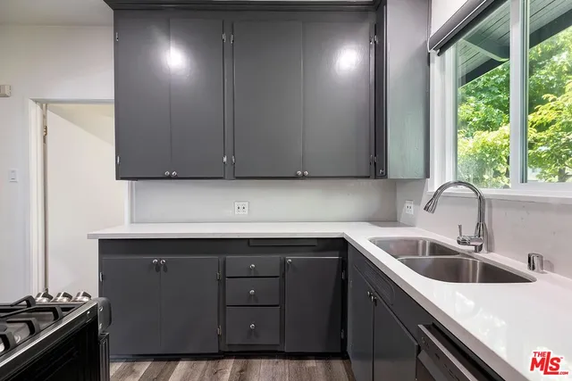 a kitchen with a sink cabinets and window