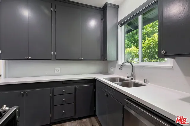 a kitchen with a sink and cabinets