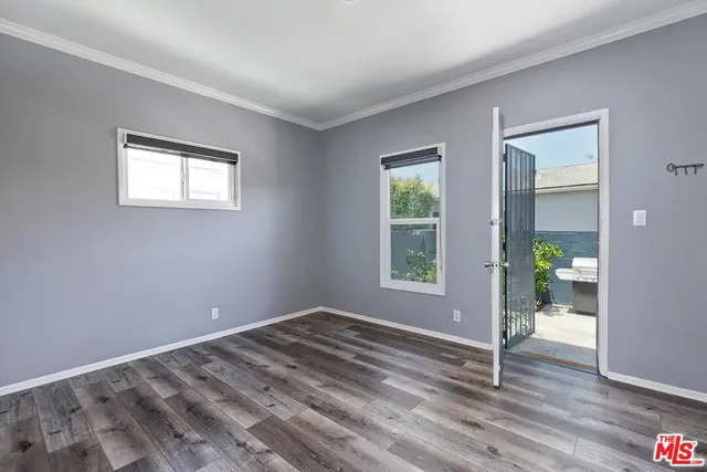a view of wooden floor and windows in a room
