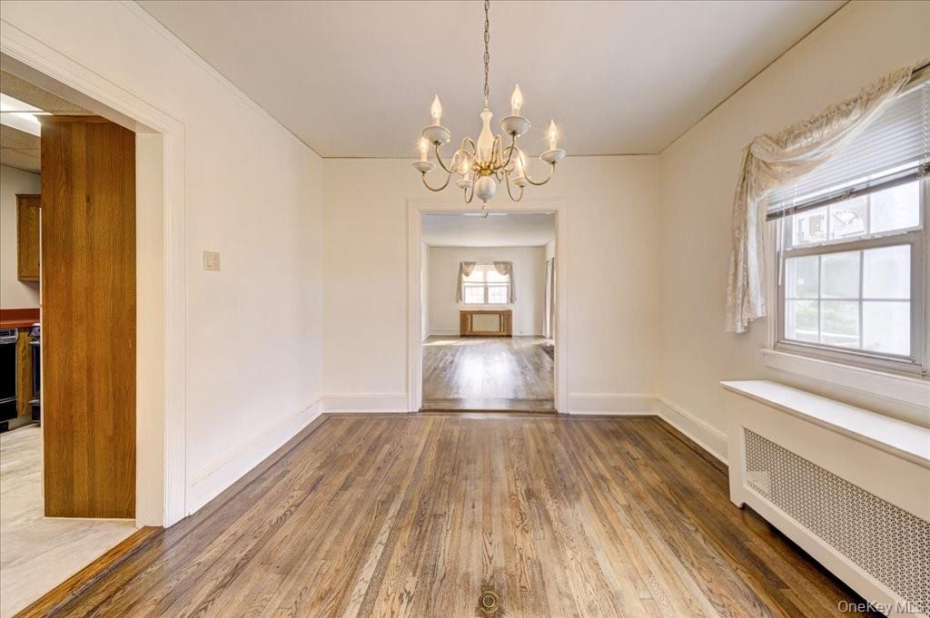 1 Rutgers Place Scarsdale, NY 10583 - Photo 14 of 29 a view of a room with wooden floor and chandelier