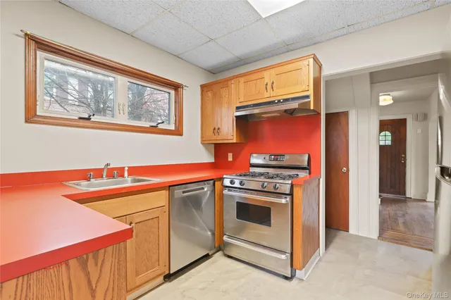 a kitchen with stainless steel appliances a stove and a microwave