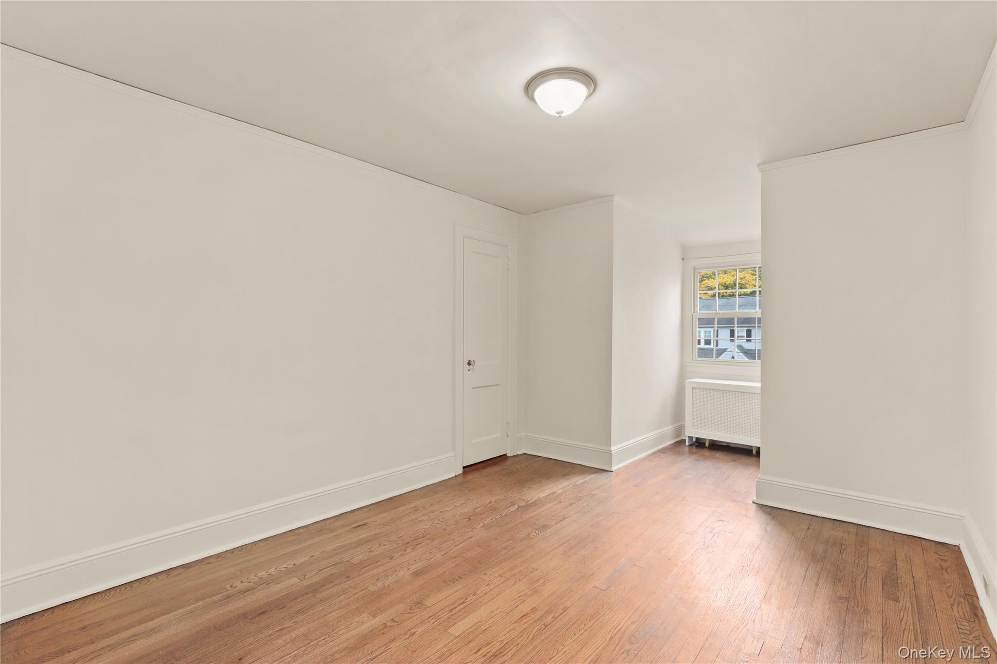 1 Rutgers Place Scarsdale, NY 10583 - Photo 24 of 29 an empty room with wooden floor and windows