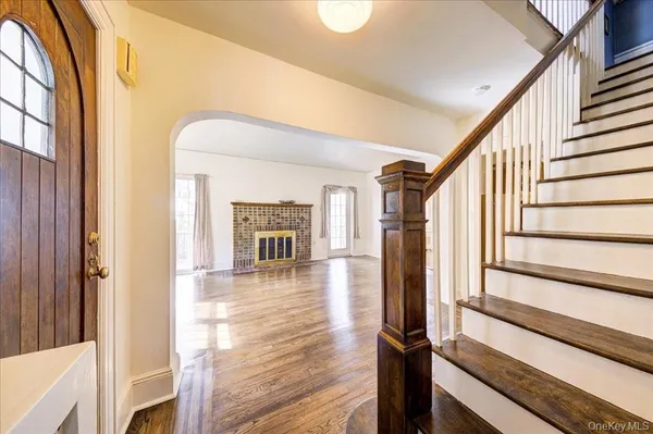 a view of a hallway with wooden floor and staircase