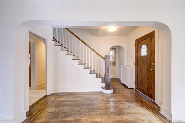 a view of entryway and hall with wooden floor
