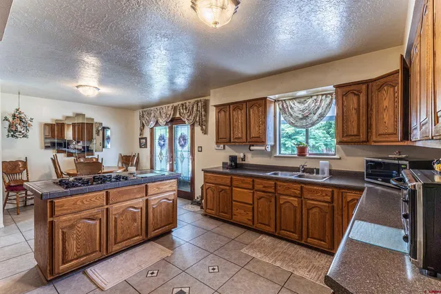 a kitchen with lots of counter top space sink and stainless steel appliances