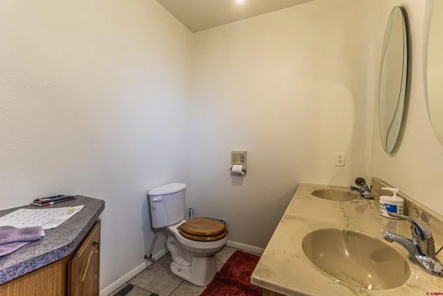 a view of house with a yard and large trees