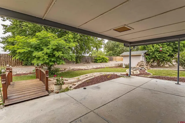 front view of a house with a yard and garage