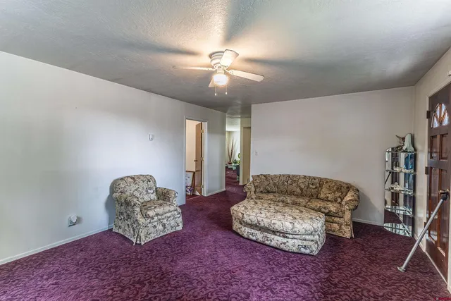 a living room with a couch and a chandelier