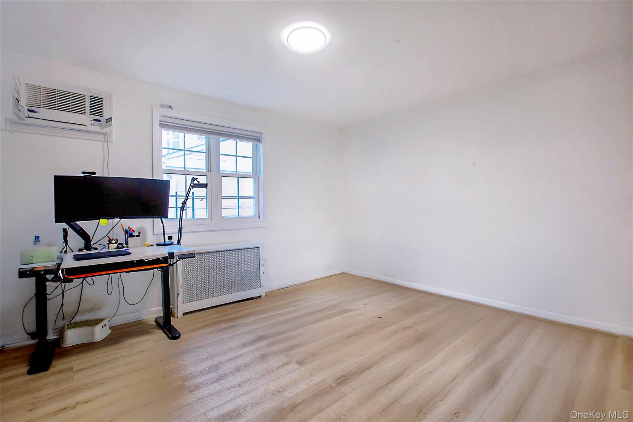 64-55 Springfield Boulevard, Unit 6455 Queens, NY 11364 - Photo 11 of 14 a view of a workspace with furniture and a window