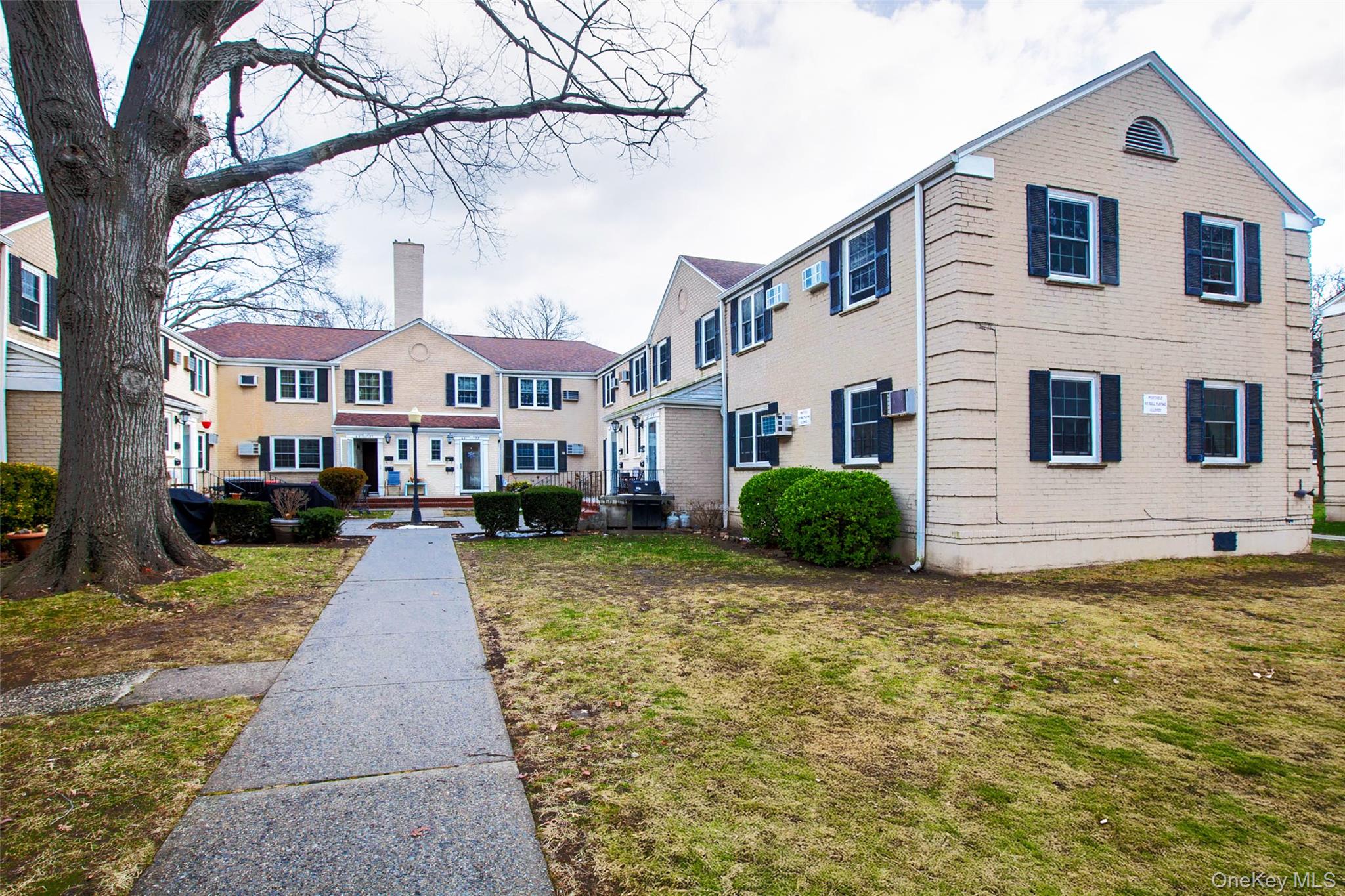 64-55 Springfield Boulevard, Unit 6455 Queens, NY 11364 - Photo 14 of 14 a view of a white house with a yard