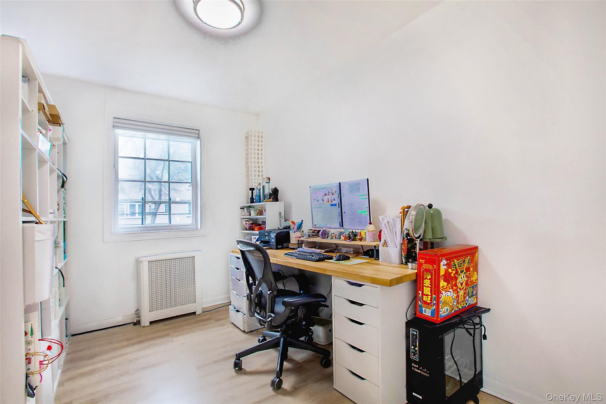 64-55 Springfield Boulevard, Unit 6455 Queens, NY 11364 - Photo 5 of 14 a view of a workspace with furniture and wooden floor