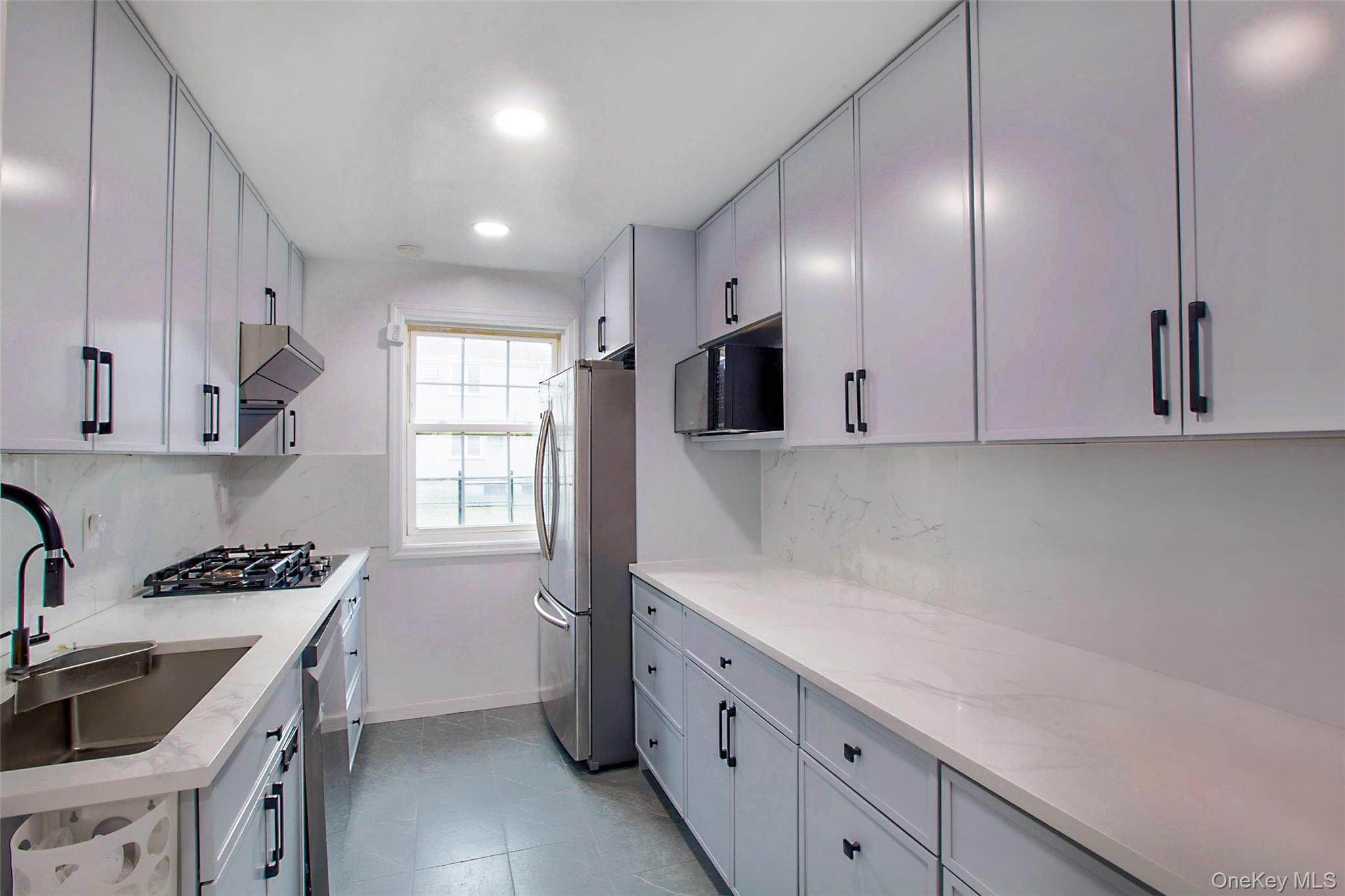 64-55 Springfield Boulevard, Unit 6455 Queens, NY 11364 - Photo 6 of 14 a kitchen that has a lot of cabinets in it and wooden floors