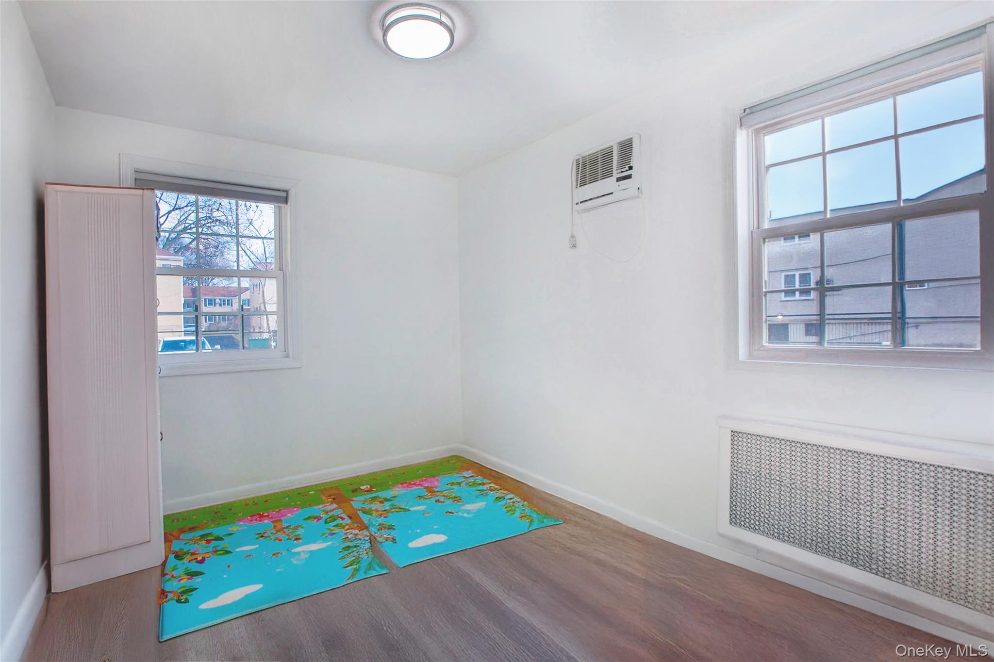 64-55 Springfield Boulevard, Unit 6455 Queens, NY 11364 - Photo 9 of 14 a room with a bed and a window