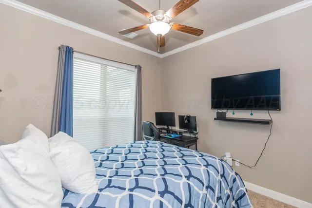 a bedroom with a bed and a flat screen tv