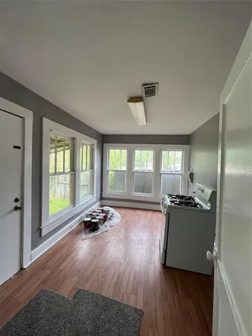 a living room with furniture and large windows