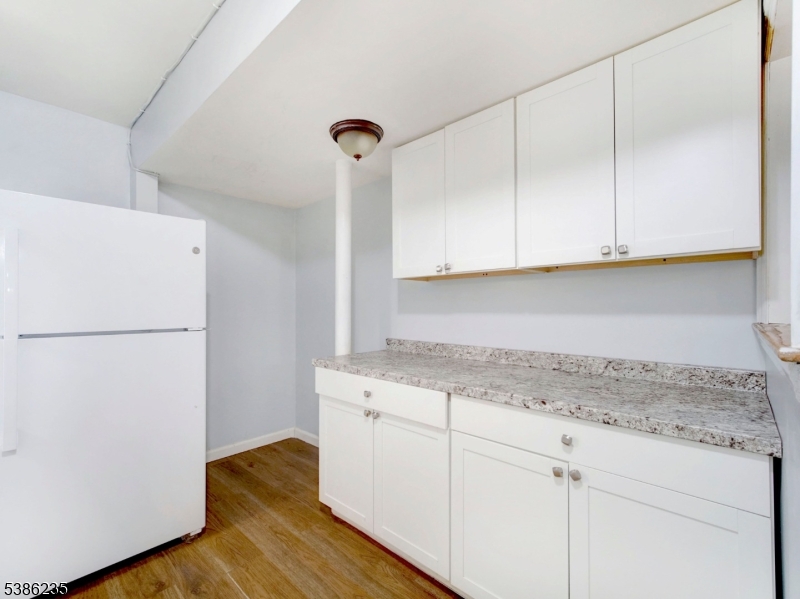 33 Kent Street Newark, NJ 07108 - Photo 7 of 12 a kitchen with a sink and a refrigerator