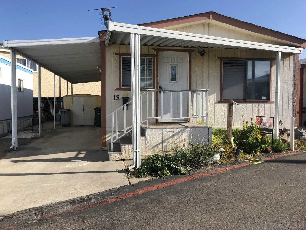 9459 Mission Gorge Road, Unit 13 Santee, CA 92071 - Photo 1 of 11 a front view of a house with a yard