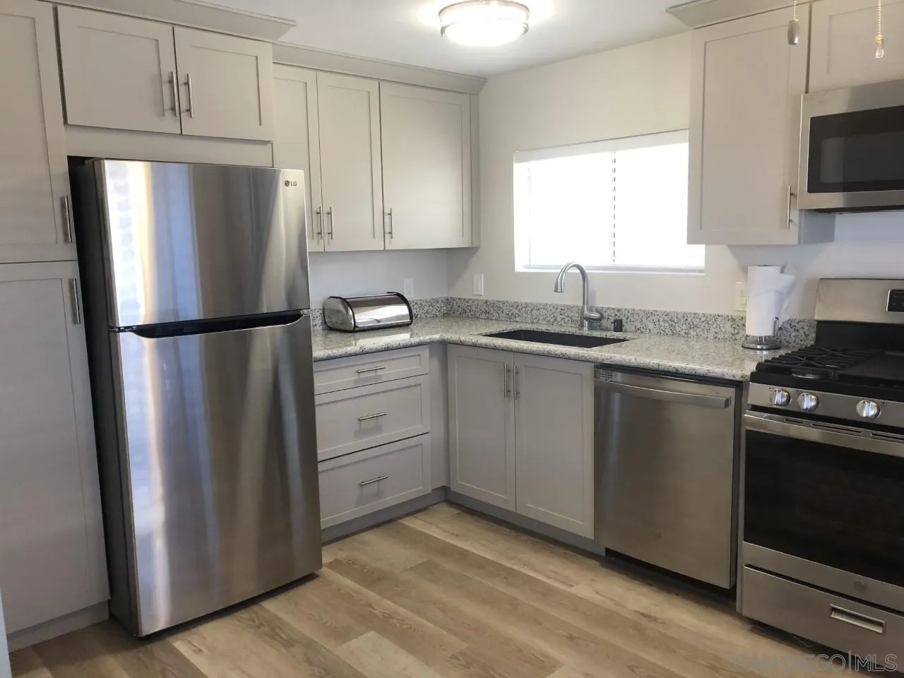 9459 Mission Gorge Road, Unit 13 Santee, CA 92071 - Photo 2 of 11 a kitchen with a refrigerator sink and microwave