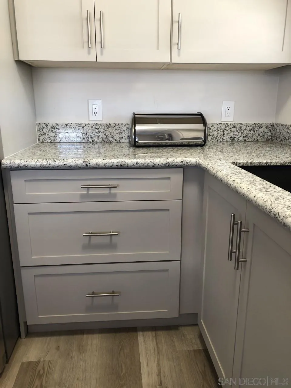 9459 Mission Gorge Road, Unit 13 Santee, CA 92071 - Photo 4 of 11 a kitchen with granite countertop cabinets and white appliances