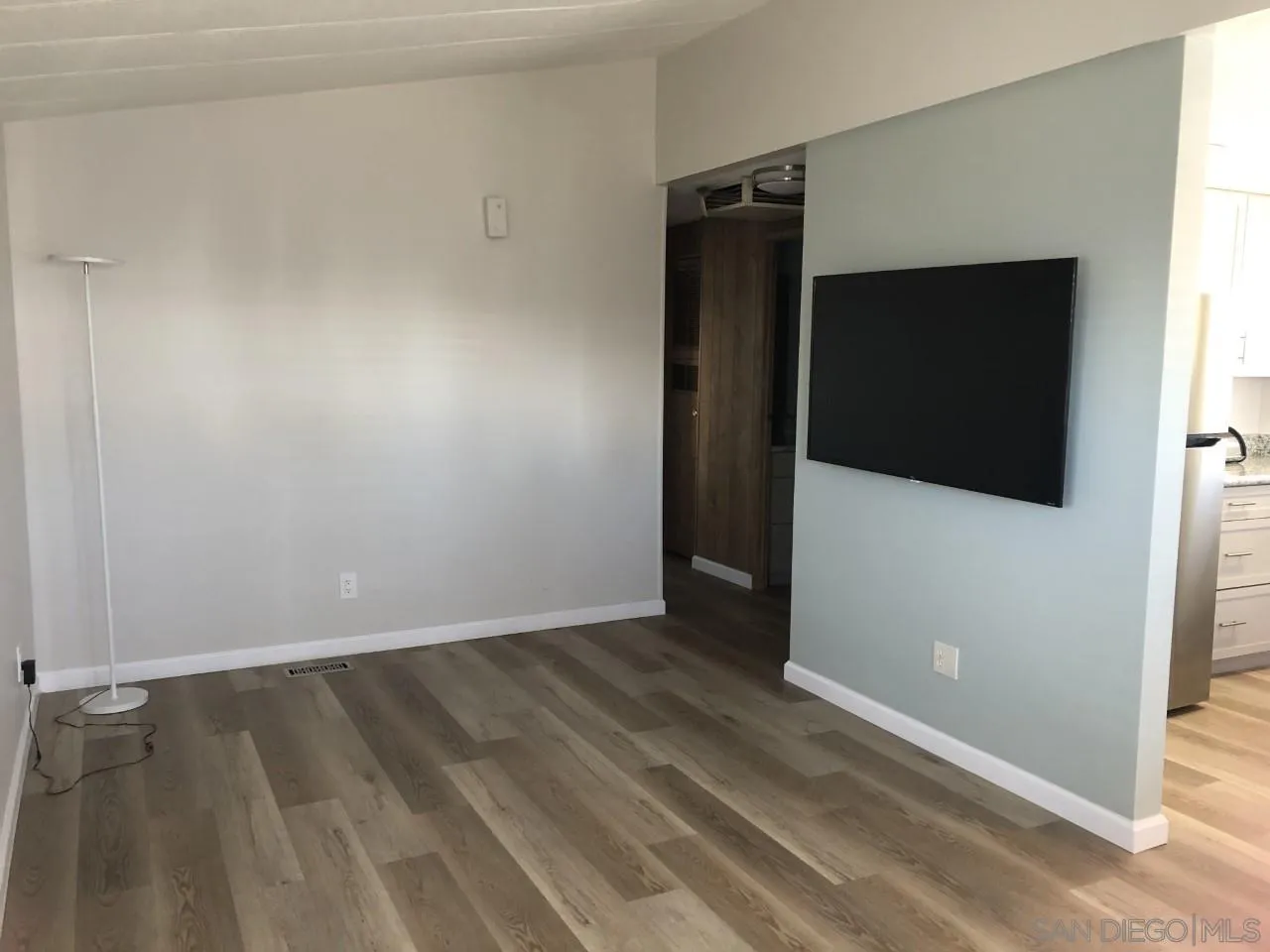 9459 Mission Gorge Road, Unit 13 Santee, CA 92071 - Photo 5 of 11 a view of an empty room with wooden floor and a window