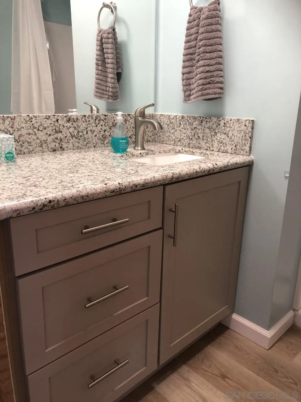 9459 Mission Gorge Road, Unit 13 Santee, CA 92071 - Photo 6 of 11 a bathroom with a granite countertop sink and a mirror