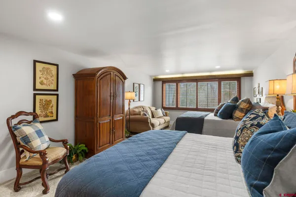 a bedroom with a bed and glass windows
