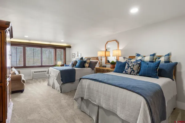 a bed room with a bed and a large window