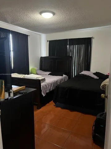 a bedroom with a bed and a television