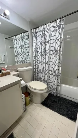 a bathroom with a toilet a sink and a shower
