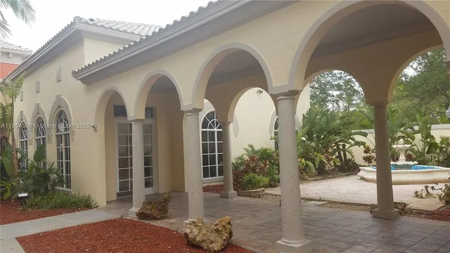 a front view of a house with garden