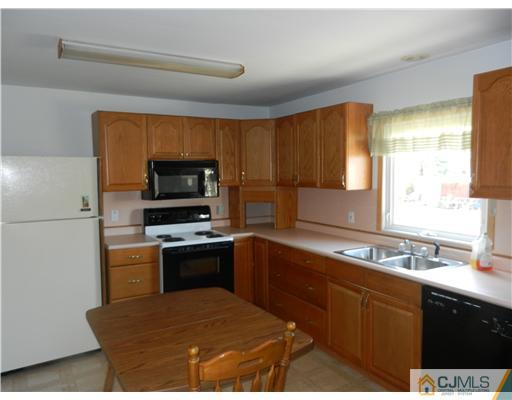 17 Ashley Road Edison, NJ 08817 - Photo 13 of 20 a kitchen with a sink appliances and cabinets