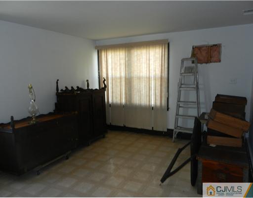 17 Ashley Road Edison, NJ 08817 - Photo 18 of 20 a living room with furniture and a gate