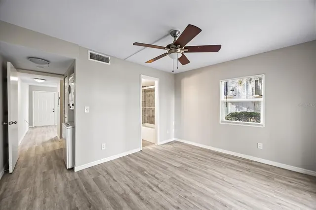 a view of empty room with wooden floor