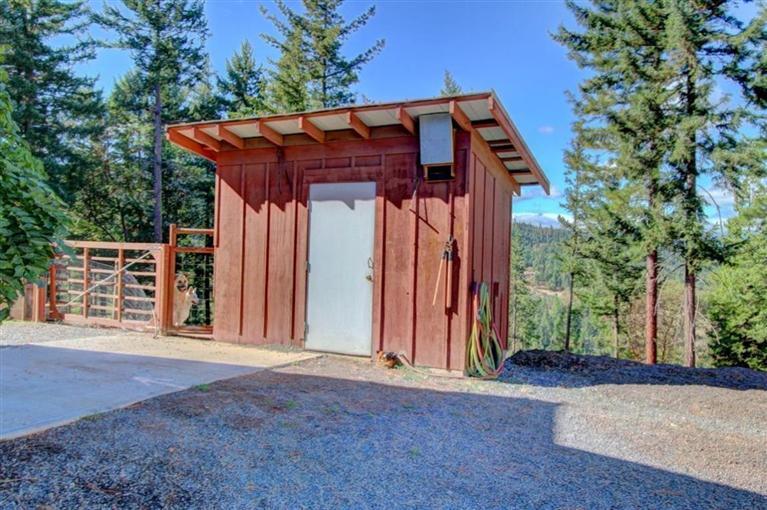 267 Citadel Road Trail, OR 97541 - Photo 21 of 30 a view of a house with wooden fence and large trees