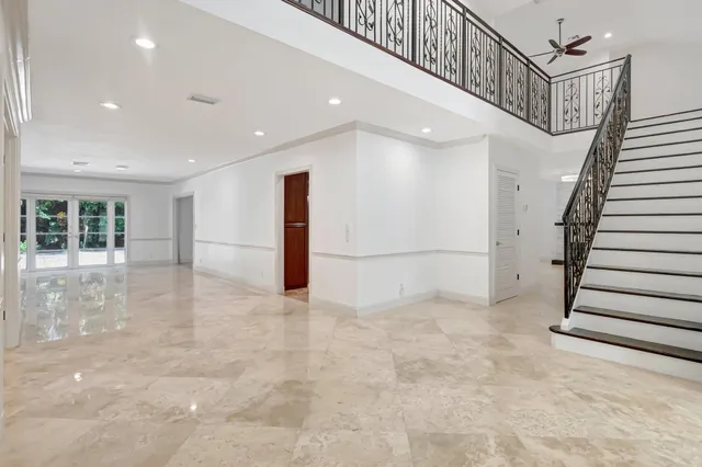 a view of a living room kitchen with stainless steel appliances wooden floor and living room view