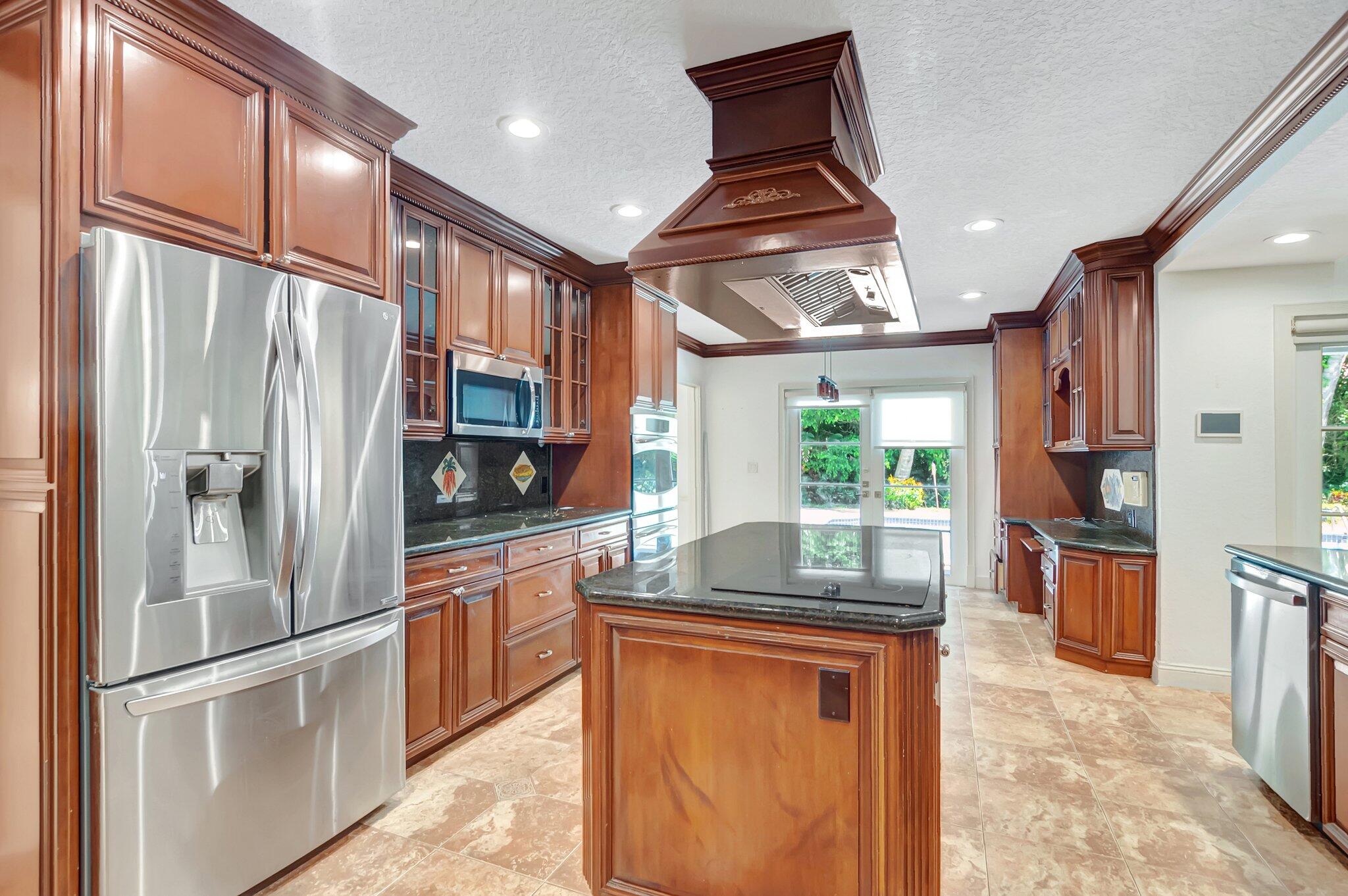 930 Parkside Circle North Boca Raton, FL 33486 - Photo 21 of 81 a kitchen with stainless steel appliances granite countertop a refrigerator a stove a sink and a microwave