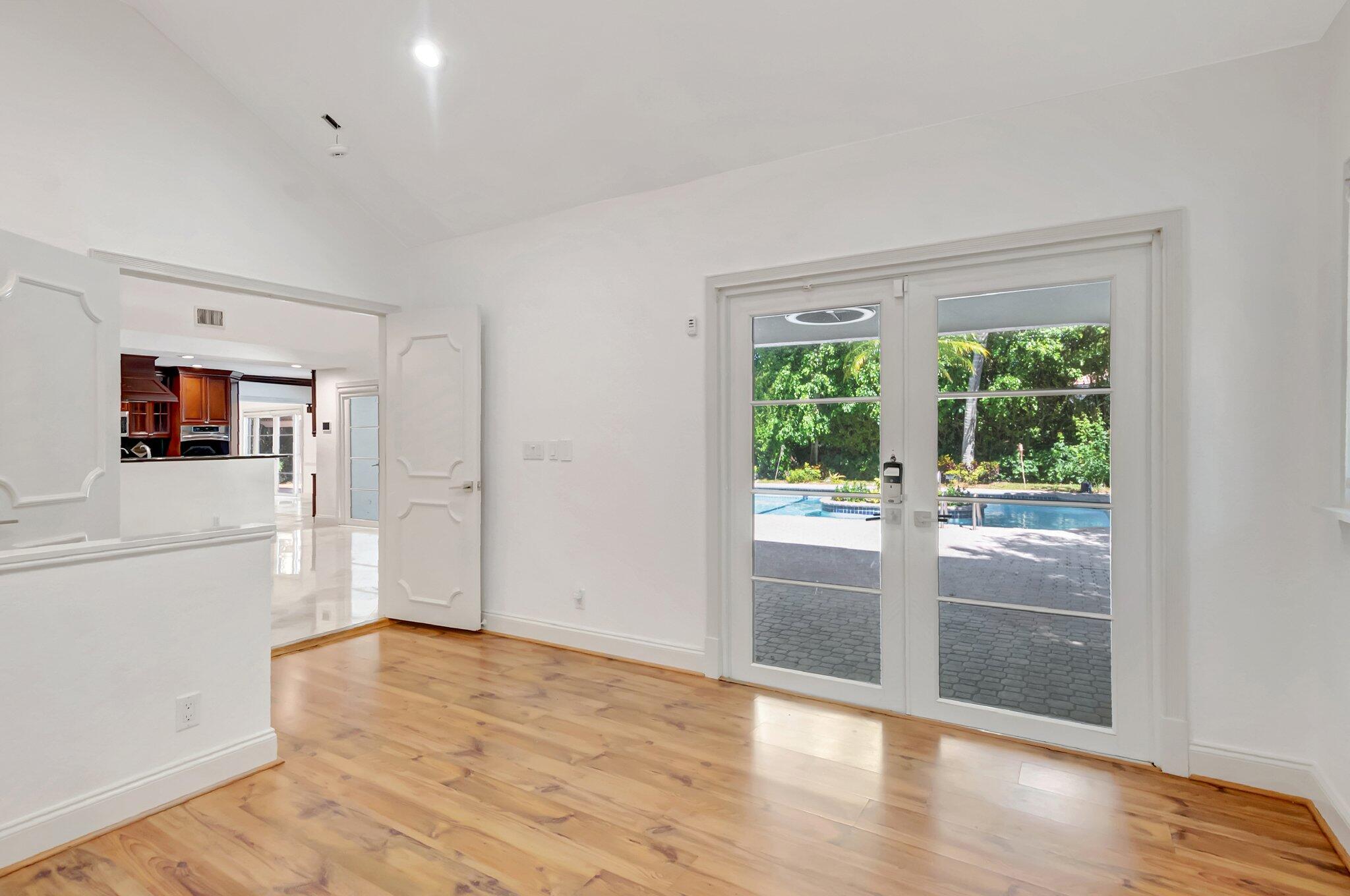 930 Parkside Circle North Boca Raton, FL 33486 - Photo 31 of 81 a view of a big room with wooden floor kitchen view and windows