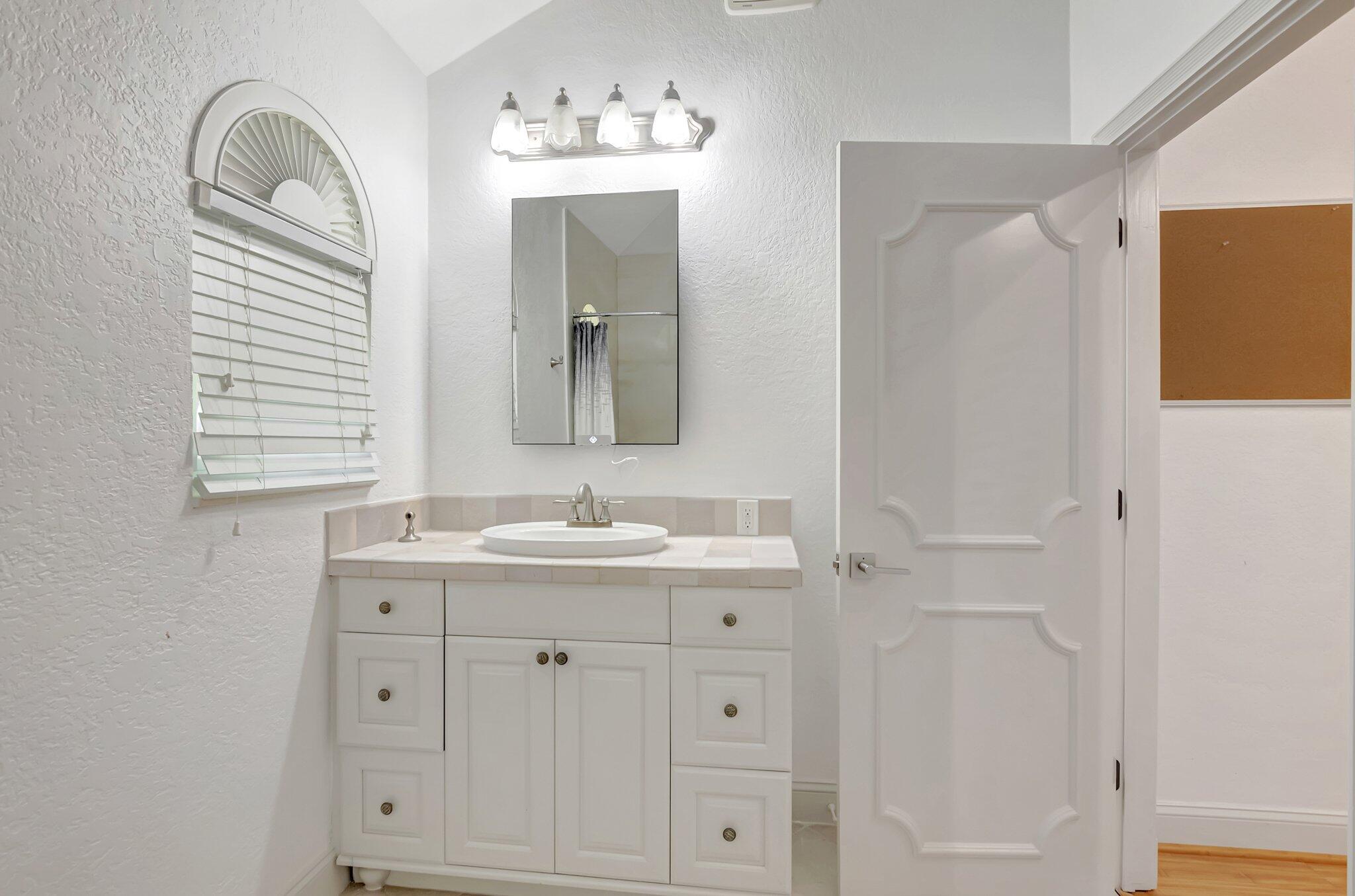 930 Parkside Circle North Boca Raton, FL 33486 - Photo 35 of 81 a bathroom with a double vanity sink and mirror