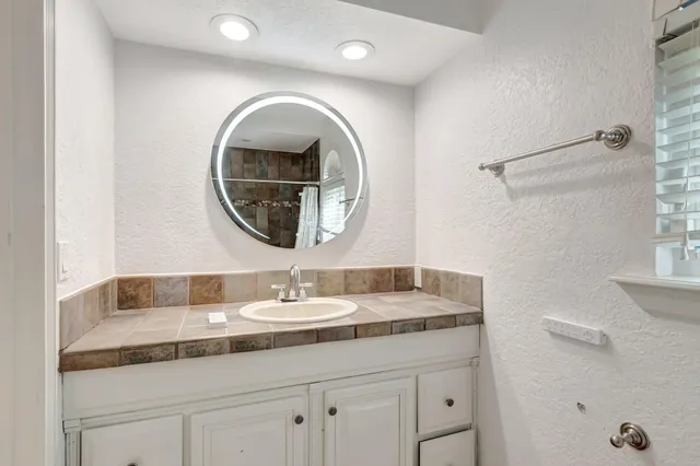 a view of empty room with wooden floor and windows