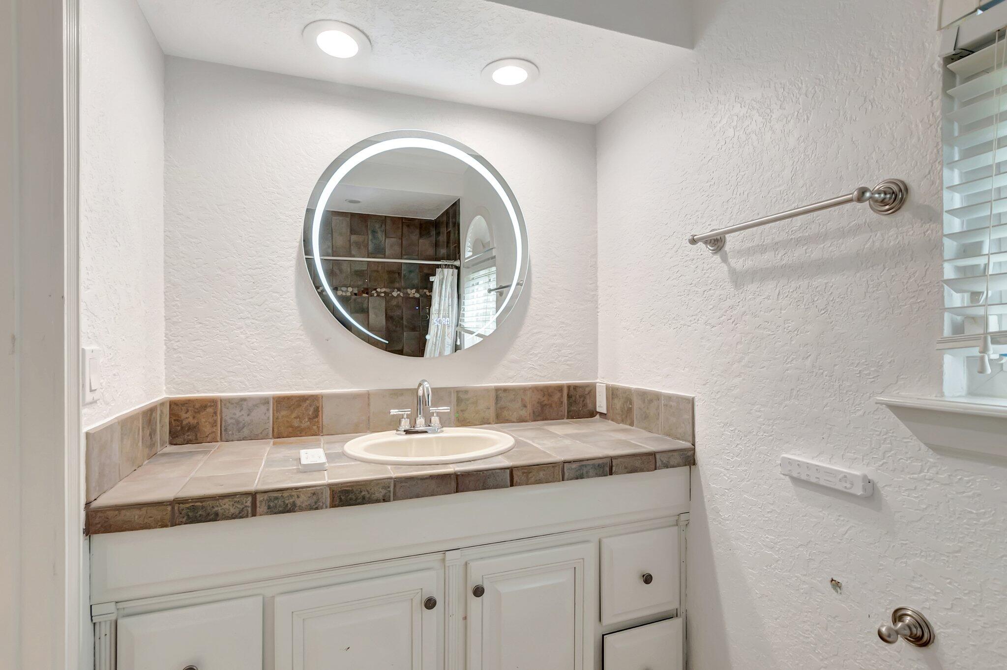 930 Parkside Circle North Boca Raton, FL 33486 - Photo 39 of 81 a bathroom with a sink and a mirror