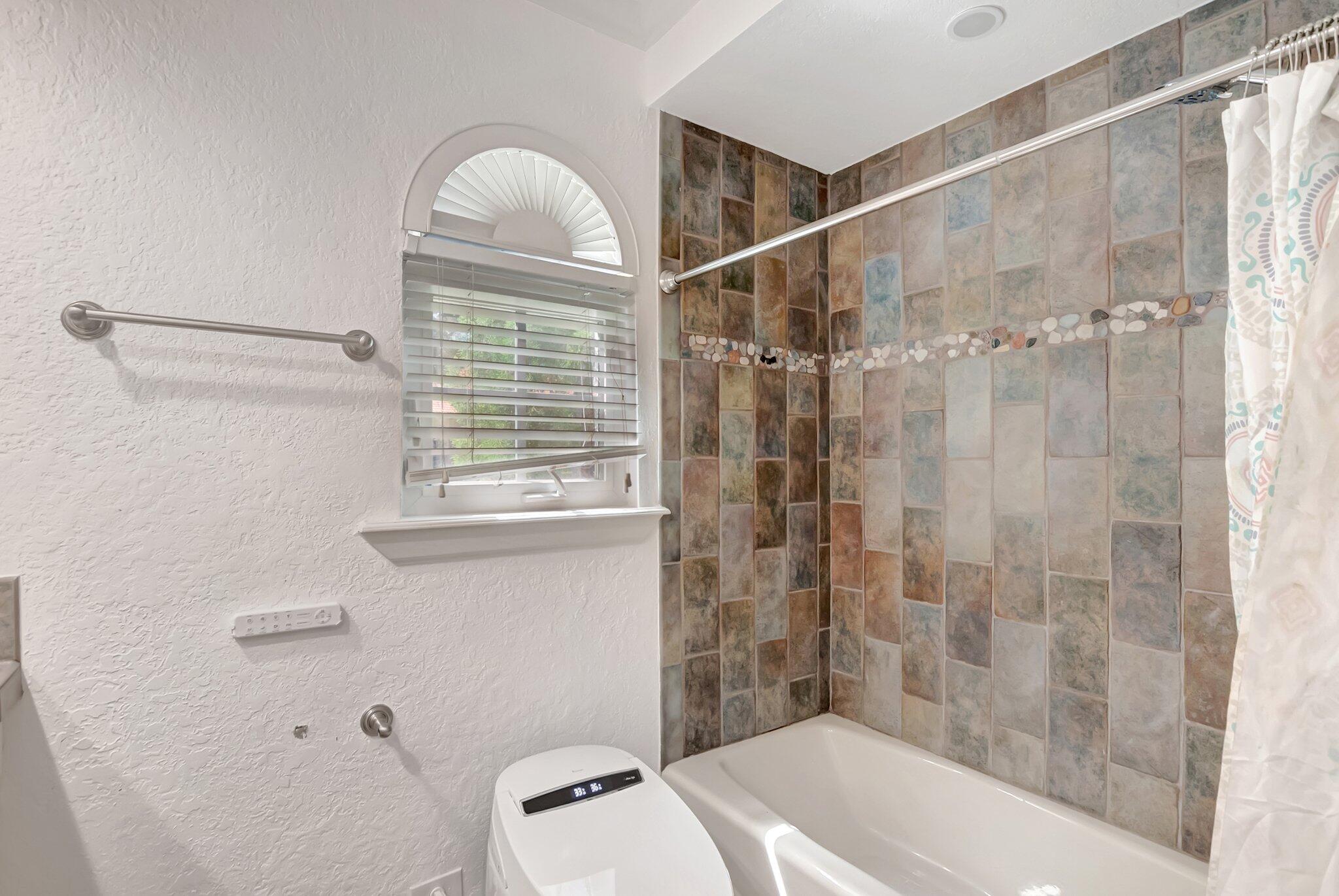 930 Parkside Circle North Boca Raton, FL 33486 - Photo 40 of 81 a bathroom with a window a sink and a shower