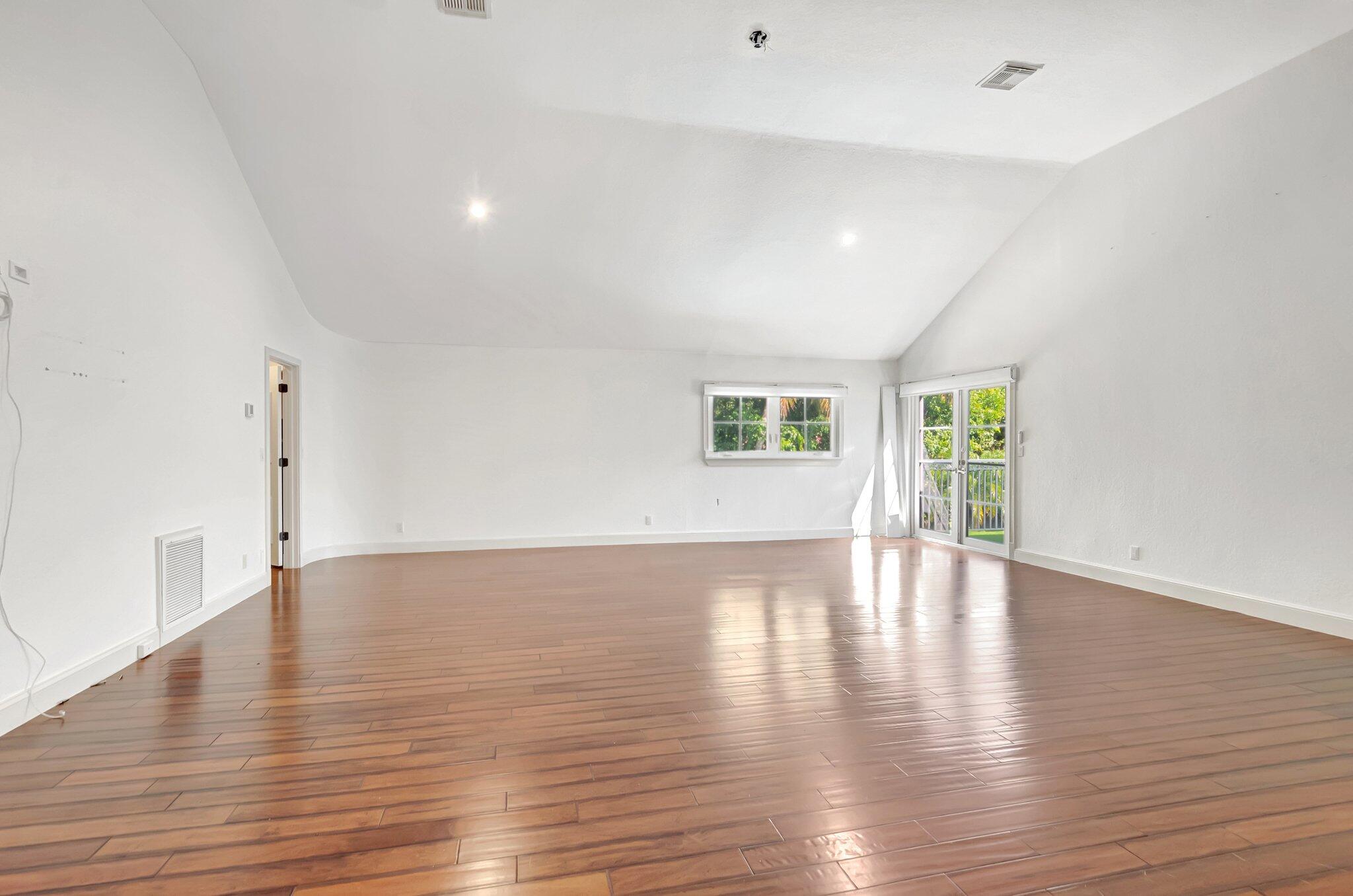 930 Parkside Circle North Boca Raton, FL 33486 - Photo 59 of 81 a view of an empty room with wooden floor and a window