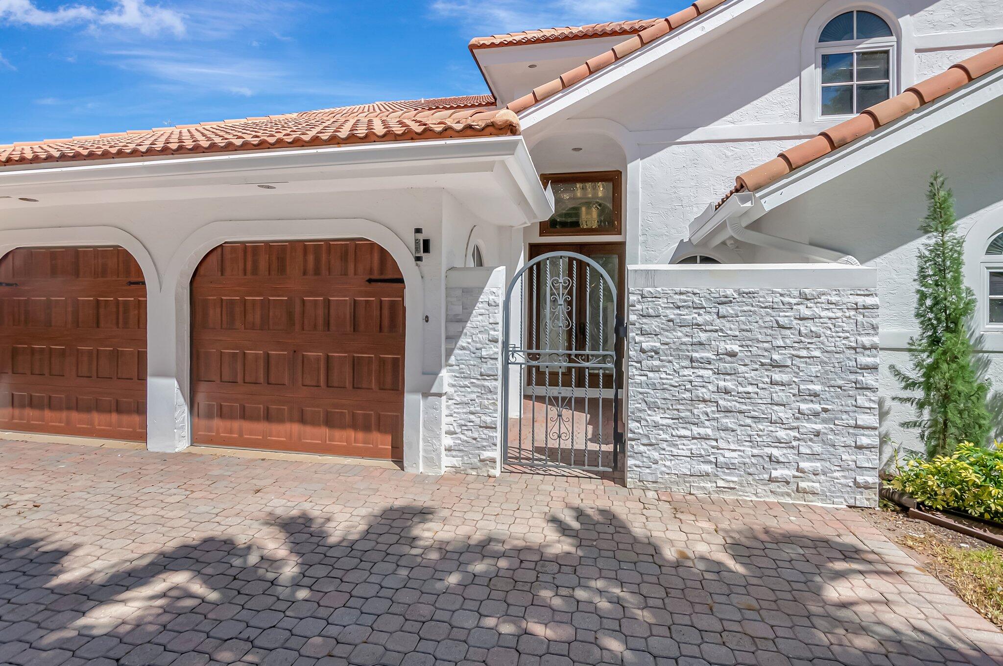 930 Parkside Circle North Boca Raton, FL 33486 - Photo 6 of 81 a front view of a house with a garage