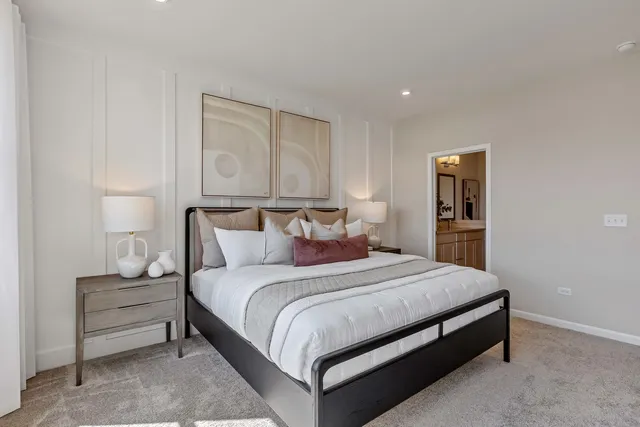 a bedroom with a bed and a night stand