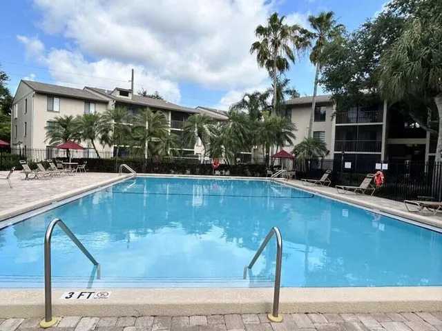 a swimming pool with outdoor seating